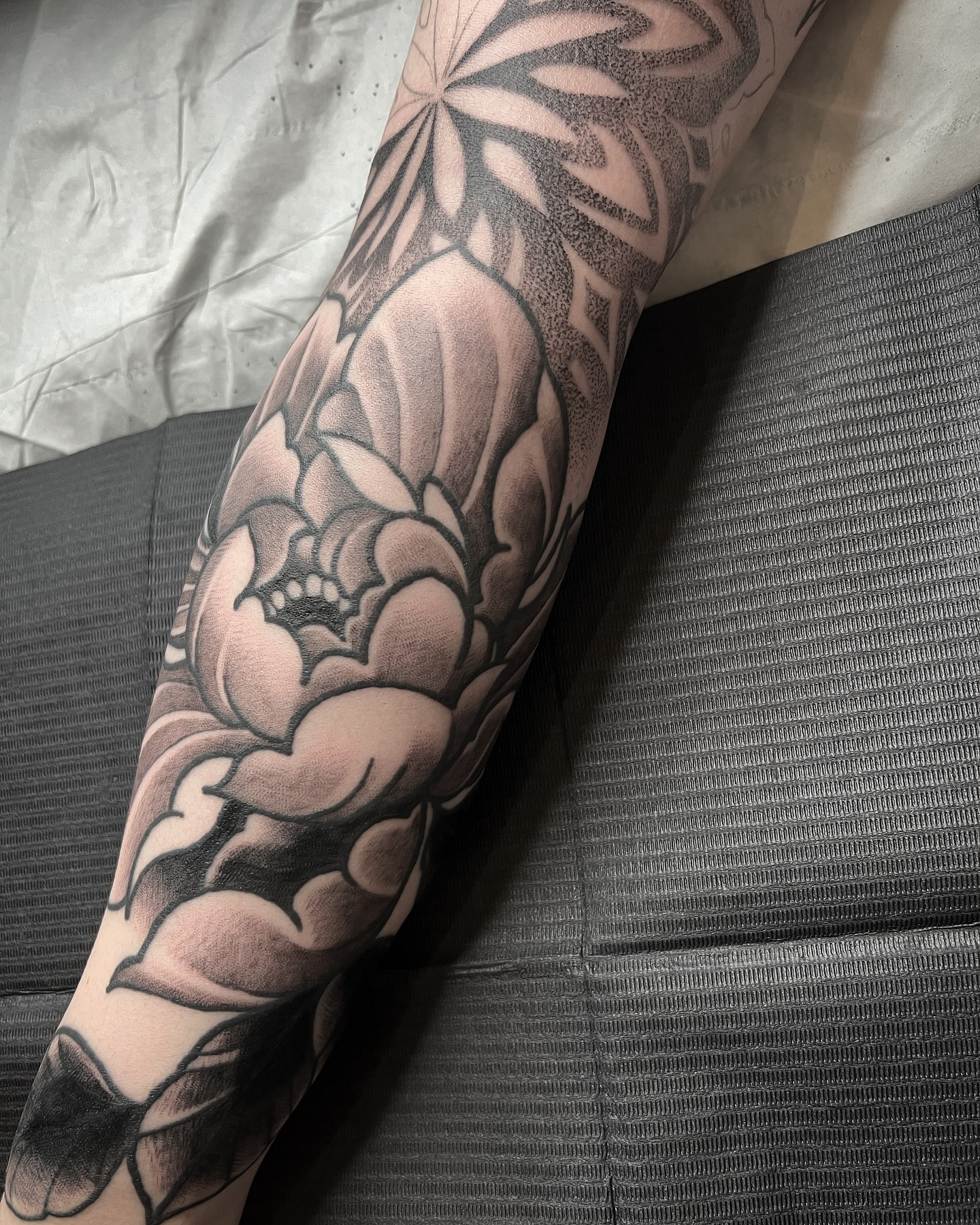 Sneak peak of @_montanamarie sleeve. This was a piece I drew as a concept and was thrilled when she took it on, thanks to all of you that choose these designs ?? #tattoos #tattoostyle #tattooideas #tattooartist #tattoosofinstagram #sleeve #sleevetattoo #blackandgreytattoo #peony #dotwork #geometric #ink #inkedgirls